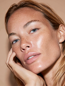 Woman with freckles and dewy skin
