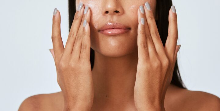 Woman applying skincare to her face