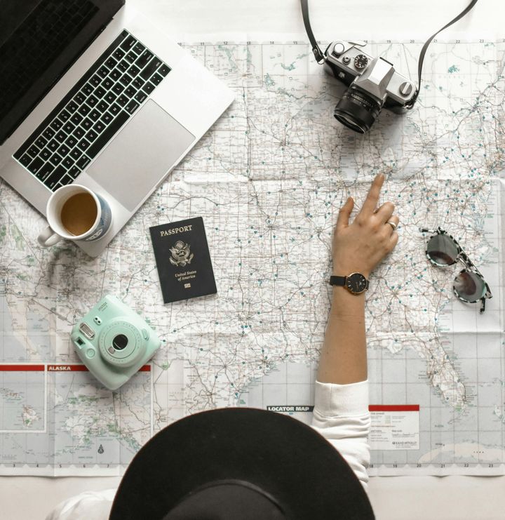 Trip planning with map, passport and sunglasses